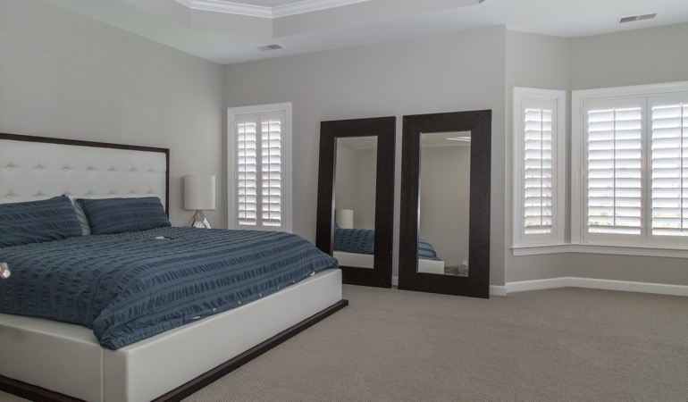 Polywood shutters in a minimalist bedroom in Denver.